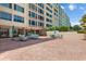 Brick paved patio with seating areas and views of the building at 700 Mirror Nw Ter # 111, Winter Haven, FL 33881