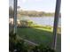 Beautiful water view from a picture window with green space and boats docked in the background at 700 Mirror Nw Ter # 111, Winter Haven, FL 33881