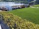 Beautiful waterfront view with a dock, boat, and lush greenery at 700 Mirror Nw Ter # 111, Winter Haven, FL 33881