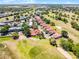 Beautiful aerial view of villa community on a golf course with lush green fairways and manicured lawns at 7016 Village Dr, Lake Wales, FL 33898