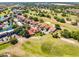 An aerial view of a property nestled in a vibrant community, featuring lush green golf course, and a serene pond at 7016 Village Dr, Lake Wales, FL 33898