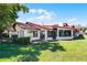 Beautiful backyard with well-maintained lawn, views of the golf course, patio and screened in lanai at 7016 Village Dr, Lake Wales, FL 33898