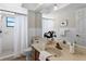 Bathroom featuring a shower with curtains and a single marble sink with white tiles on the wall at 7016 Village Dr, Lake Wales, FL 33898