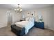 Charming bedroom featuring a stylish chandelier, comfortable bed, and elegant decor at 7016 Village Dr, Lake Wales, FL 33898