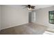 Large bedroom with neutral colors and carpeted floors at 7016 Village Dr, Lake Wales, FL 33898
