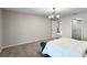 Spacious bedroom with neutral tones, carpeted floors and an open doorway at 7016 Village Dr, Lake Wales, FL 33898