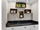 Stylish countertop with granite surface, decoratively adorned with plants, mugs, and offering extra cabinet space at 7016 Village Dr, Lake Wales, FL 33898