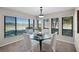Bright dining room features a round glass table, comfortable seating, and expansive windows showcasing outdoor views at 7016 Village Dr, Lake Wales, FL 33898