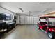 Spacious garage featuring a golf cart and custom storage, offering ample space for vehicles and hobbies at 7016 Village Dr, Lake Wales, FL 33898