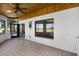 Enclosed lanai with tiled floors, sliding glass doors, and a ceiling fan at 7016 Village Dr, Lake Wales, FL 33898