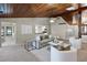 Inviting living room with wood ceiling and a view of the kitchen at 7016 Village Dr, Lake Wales, FL 33898