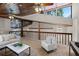 Second floor living room showcasing wood ceilings and railings providing an open and airy atmosphere at 7016 Village Dr, Lake Wales, FL 33898