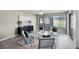 Bright sitting area with tiled flooring and views of the green exterior at 7016 Village Dr, Lake Wales, FL 33898