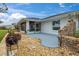 The back patio features a screened-in porch, decorative rock landscaping and privacy wall at 734 Canberra Rd, Winter Haven, FL 33884