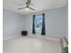 Minimalist bedroom featuring white tile floors, a dark ottoman, and bright natural light at 734 Canberra Rd, Winter Haven, FL 33884
