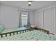 Bright bedroom featuring twin beds, large window, and neutral colored walls at 734 Canberra Rd, Winter Haven, FL 33884