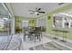 Light-filled dining area featuring a modern ceiling fan and access to the outdoor patio at 734 Canberra Rd, Winter Haven, FL 33884