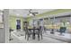 Sunlit dining area featuring sliding glass doors to the screened patio and golf course views at 734 Canberra Rd, Winter Haven, FL 33884