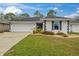 Charming single-story home with a well-manicured lawn and attached two car garage at 734 Canberra Rd, Winter Haven, FL 33884