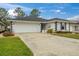Well-maintained single-Gathering home with an attached two car garage and a driveway at 734 Canberra Rd, Winter Haven, FL 33884