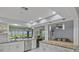 Bright kitchen with white cabinetry, stainless steel appliances, and views to other living areas at 734 Canberra Rd, Winter Haven, FL 33884