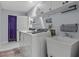 Functional laundry room with modern appliances, a utility sink, and ample storage space at 734 Canberra Rd, Winter Haven, FL 33884