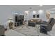 Inviting living room featuring a comfortable gray sofa, TV, and cozy lighting at 734 Canberra Rd, Winter Haven, FL 33884