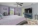 Comfortable main bedroom with a ceiling fan, sitting area, and large window with natural light at 734 Canberra Rd, Winter Haven, FL 33884