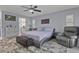 Spacious main bedroom with a ceiling fan, ensuite bathroom and a sitting area at 734 Canberra Rd, Winter Haven, FL 33884