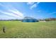 Spacious backyard featuring lush green lawn and views of the surrounding neighborhood and community at 9461 Redhawk Bend Ln, Lakeland, FL 33810