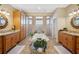 Large bathroom boasts dual vanities and a tub set into a tiled surround at 9461 Redhawk Bend Ln, Lakeland, FL 33810