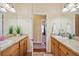 Double vanity bathroom with granite tops and lots of natural light at 9461 Redhawk Bend Ln, Lakeland, FL 33810