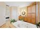 The bathroom includes a soaking tub with jets, wood cabinets and granite countertops at 9461 Redhawk Bend Ln, Lakeland, FL 33810