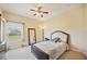 Bright bedroom featuring a full-length mirror and large window at 9461 Redhawk Bend Ln, Lakeland, FL 33810