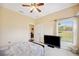 Spacious bedroom with a TV, large window, and access to another room at 9461 Redhawk Bend Ln, Lakeland, FL 33810
