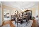 Elegant dining room boasts a dark wood table, cushioned chairs, and a decorative hutch at 9461 Redhawk Bend Ln, Lakeland, FL 33810