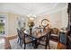Bright dining room with a large dark wood table set on a decorative area rug at 9461 Redhawk Bend Ln, Lakeland, FL 33810