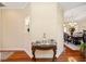 Elegant foyer with hardwood floors, decorative table, and view into dining room at 9461 Redhawk Bend Ln, Lakeland, FL 33810