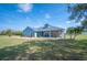 Lovely single-story home with manicured lawn and attractive blue exterior at 9461 Redhawk Bend Ln, Lakeland, FL 33810