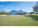 Beautiful single-story home boasting a manicured lawn and charming blue exterior at 9461 Redhawk Bend Ln, Lakeland, FL 33810