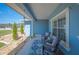 Inviting front porch with comfortable seating, decorative rug, and views of the neighborhood at 9461 Redhawk Bend Ln, Lakeland, FL 33810