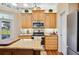Kitchen featuring stainless steel appliances, granite countertops, and wooden cabinetry at 9461 Redhawk Bend Ln, Lakeland, FL 33810