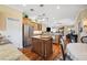 Open concept kitchen featuring stainless steel appliances and hardwood flooring at 9461 Redhawk Bend Ln, Lakeland, FL 33810