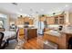 Spacious kitchen with stainless steel appliances, wooden cabinetry, and dining area at 9461 Redhawk Bend Ln, Lakeland, FL 33810