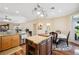 Open concept kitchen featuring stainless steel appliances, granite countertops, and hardwood flooring at 9461 Redhawk Bend Ln, Lakeland, FL 33810