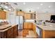 Kitchen featuring stainless steel appliances, wooden cabinets, and granite countertops at 9461 Redhawk Bend Ln, Lakeland, FL 33810