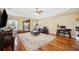 Spacious living room with hardwood floors, tray ceiling, and plenty of natural light at 9461 Redhawk Bend Ln, Lakeland, FL 33810