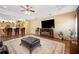 Comfortable living room with a large television, fireplace, and open kitchen at 9461 Redhawk Bend Ln, Lakeland, FL 33810