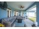 Relaxing screened patio features ample seating and a ceiling fan at 9461 Redhawk Bend Ln, Lakeland, FL 33810
