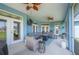 Screened patio features cozy seating, ceiling fans, and outdoor lighting for relaxing and entertaining at 9461 Redhawk Bend Ln, Lakeland, FL 33810